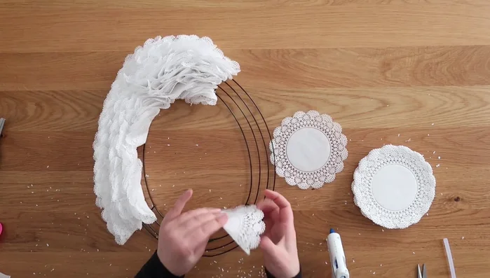 Repeat steps 1-6 until the entire wreath is covered with doilies.