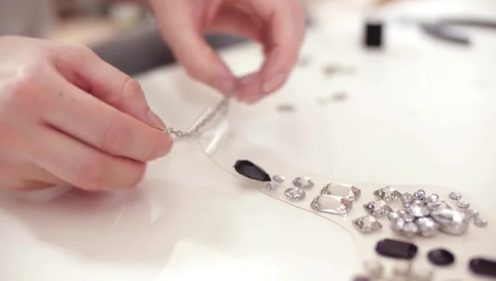 Attach a chain (measure for desired length) using a jump ring or ring from an old necklace.