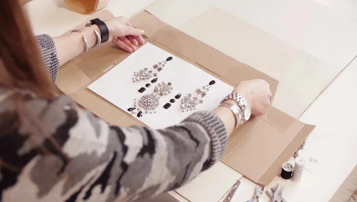 Place wood, cardboard, then PVC plastic on top. Gently slide the paper with beads onto the PVC.