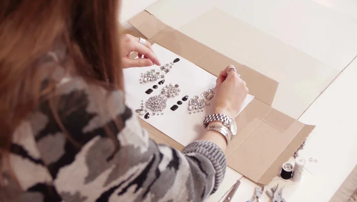 Punch holes through the PVC to create a base for the beads.