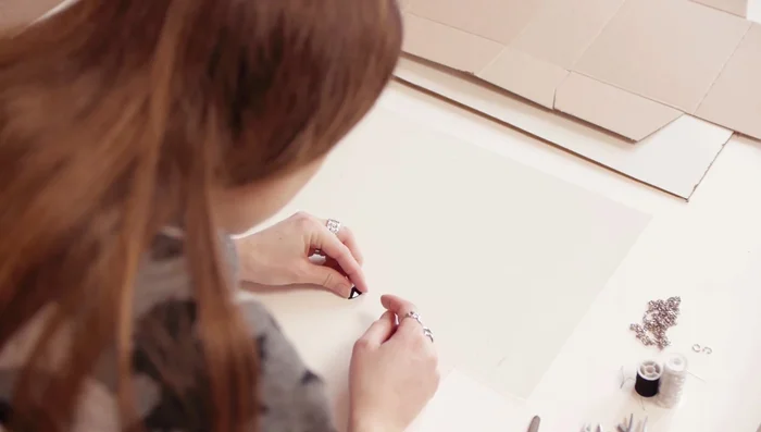 Remove PVC and sew on beads, following your planned pattern.