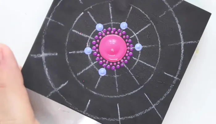 Star shape dots: Use the largest stylus tool to create four dots stemming from each of the previous dots, forming a star shape. Extend these with another color.