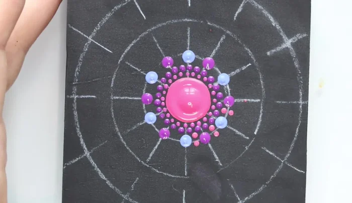 Star shape dots: Use the largest stylus tool to create four dots stemming from each of the previous dots, forming a star shape. Extend these with another color.