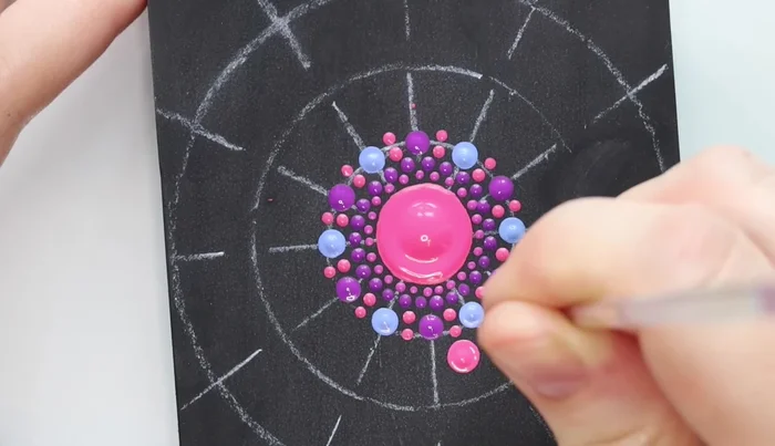 Star shape dots: Use the largest stylus tool to create four dots stemming from each of the previous dots, forming a star shape. Extend these with another color.