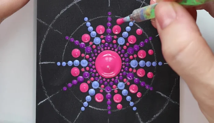 Purple dots: Use a purple rod to add large dots, touching the outer circle, on every other line. Repeat with another color.