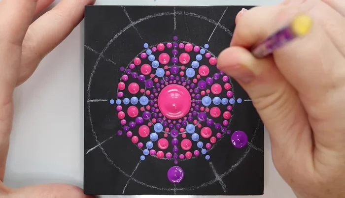 Purple dots: Use a purple rod to add large dots, touching the outer circle, on every other line. Repeat with another color.