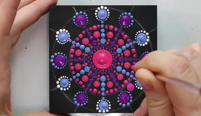 Fill in negative space: Fill in the remaining negative spaces with dots, using various colors and sizes, paying attention to the overall balance and design.