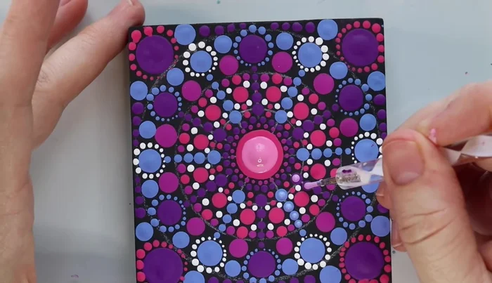 Final touches: Add final dots to fill any remaining negative space. Wipe off the stencil markings with a wet cloth. Apply matte varnish for a final finish (optional).