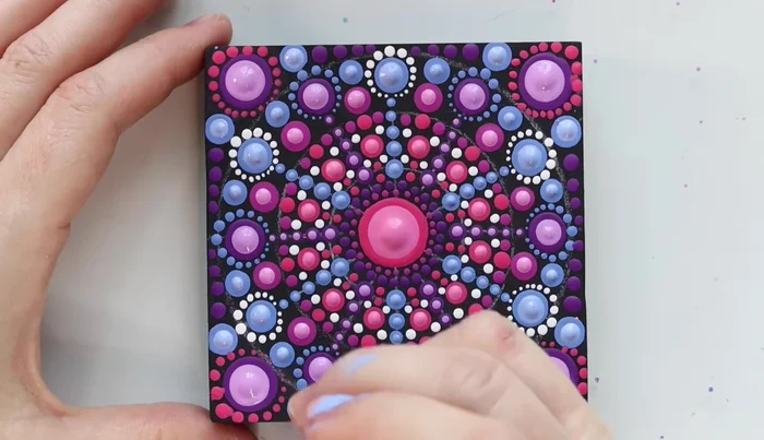 Final touches: Add final dots to fill any remaining negative space. Wipe off the stencil markings with a wet cloth. Apply matte varnish for a final finish (optional).