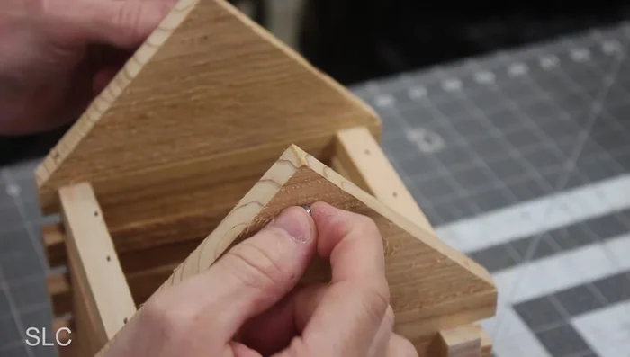 Install ice screws at the back and front of roof for hanging twine.