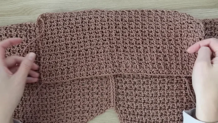 Attach sleeves: Use stitch markers to ensure the shoulder seam is centered; use slip stitch to attach sleeves to the front and back panels. Seam sides of sleeves and body, leaving a 6-inch slit on each side if desired.