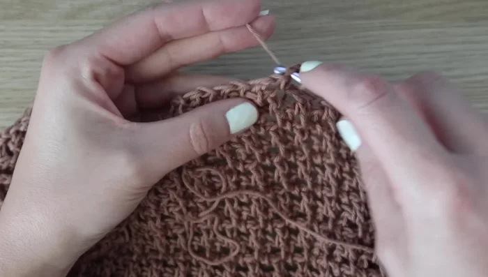 Decreasing Rows (Rows 49-59): Work decreases by skipping the first stitch in each row; alternate Rows 49 and 50 until 32 stitches remain for size small. Fasten off.