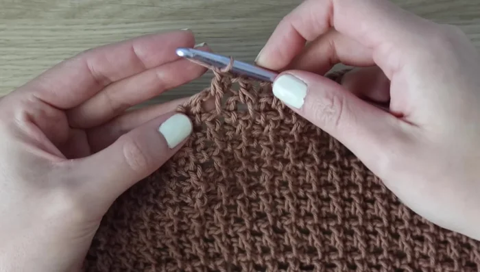 Decreasing Rows (Rows 49-59): Work decreases by skipping the first stitch in each row; alternate Rows 49 and 50 until 32 stitches remain for size small. Fasten off.