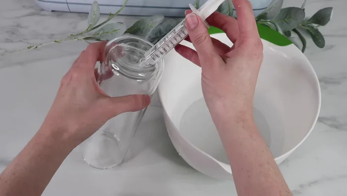 Slowly add the liquid mixture, tilting and rotating the tumbler to minimize air bubbles.