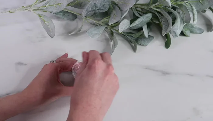 Apply tape around the rim of the tumbler to contain glitter spillage.