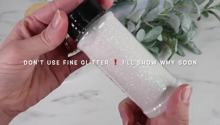 Apply tape around the rim of the tumbler to contain glitter spillage.