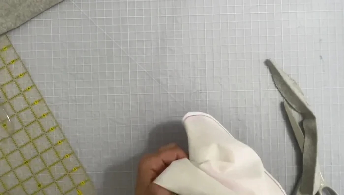 Sew the rib knitting to the bib, tucking the angled end neatly.