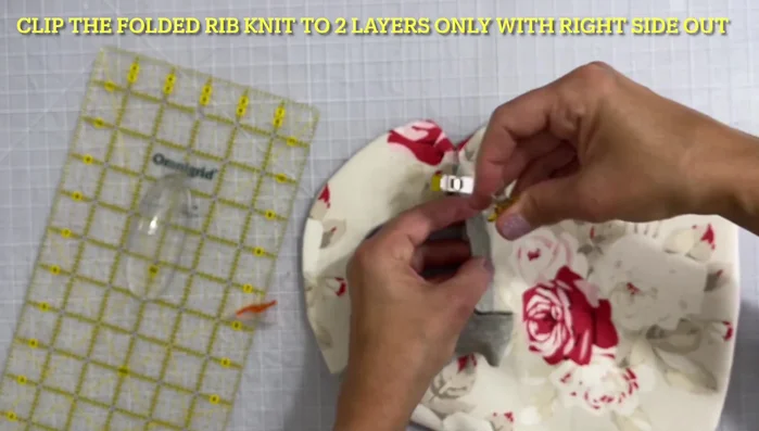 Sew the rib knitting to the bib, tucking the angled end neatly.