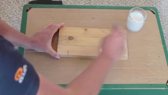 Paint the wood with a water-based paint (white or gray), brushing lightly with the grain.