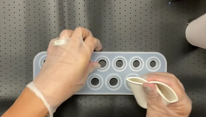 Carefully pour the resin mixture into the silicone molds.