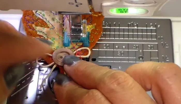 Sew a button onto the center of the leaf using a walking stitch.