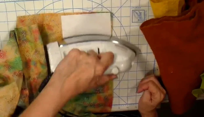 Cut HeatnBond Lite to the same size as your die and iron it onto the back of your fabrics.