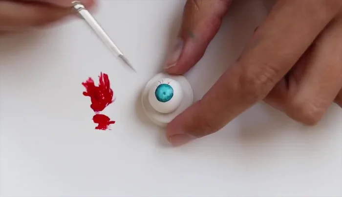 Add thin veins around the iris using a high-quality fine detail brush.