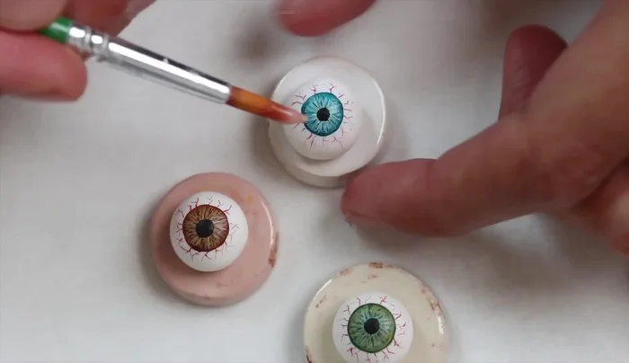 Add varnish after the paint is fully dry (ensure your varnish is bake-able, or varnish at the very end if not).