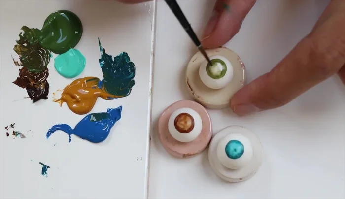 Add thin veins around the iris using a high-quality fine detail brush.