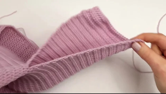 Sew sleeve edges together using mattress stitch. Fasten off. Repeat for second sleeve.