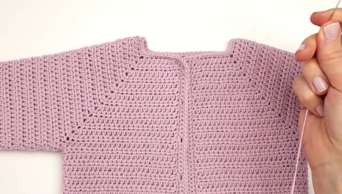 Sew buttons onto the opposite side of the buttonholes.