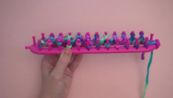 Repeating steps 3 and 4 until only 12 inches of yarn remain. Attaching a second ball of yarn by knotting the ends and tucking them in.