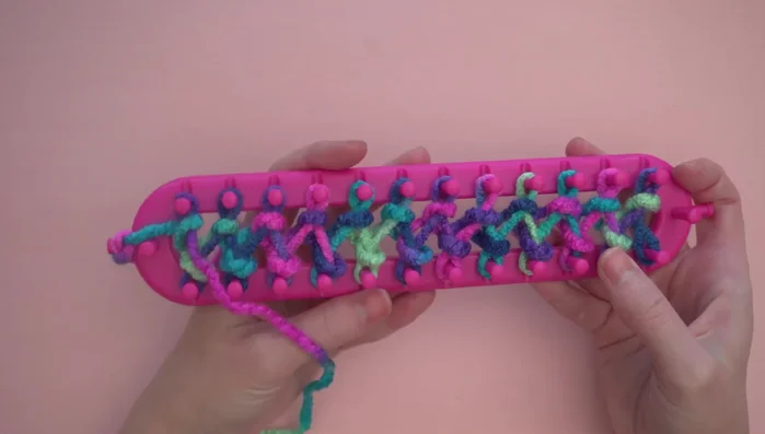 Repeating steps 3 and 4 until only 12 inches of yarn remain. Attaching a second ball of yarn by knotting the ends and tucking them in.