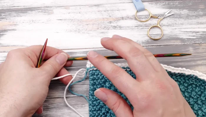 Cast on 18 stitches using a knitted cast-on method. Bind off these 18 stitches to create a hanger.
