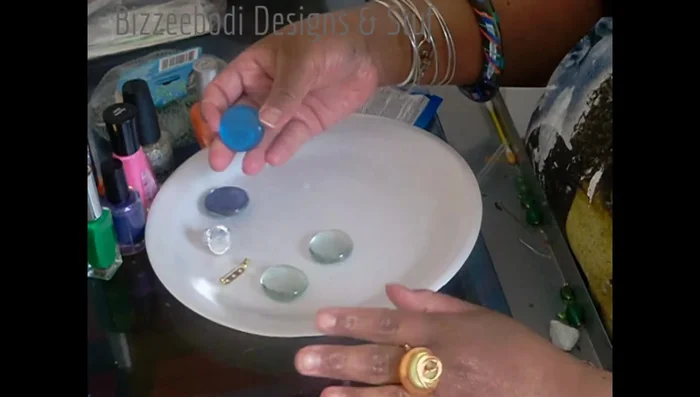 Apply a base coat of nail polish to the glass gems. Let it dry completely (around 30 minutes per layer).