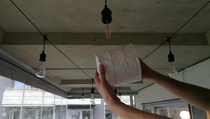 Hang the lantern using a false light bulb (method shown in video).