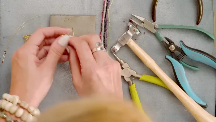 Bend the paddle over the edge of the ring and down, securing it with rawhide mallet.