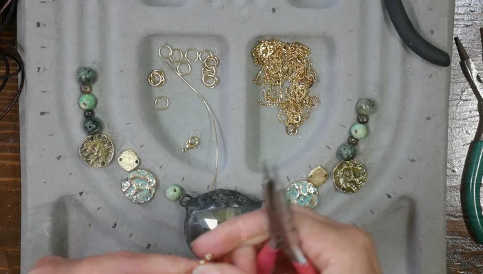 Attach the necklace chain: Use jump rings to attach a multi-strand chain with a lobster claw clasp.