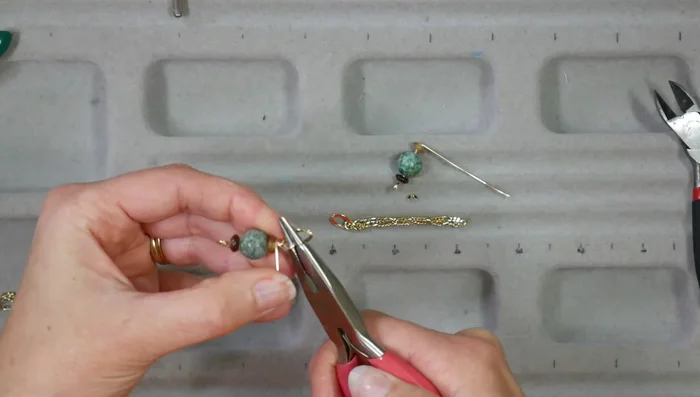 Make matching earrings: String beads, create a wrapped loop, attach chain, and add to ear wires.