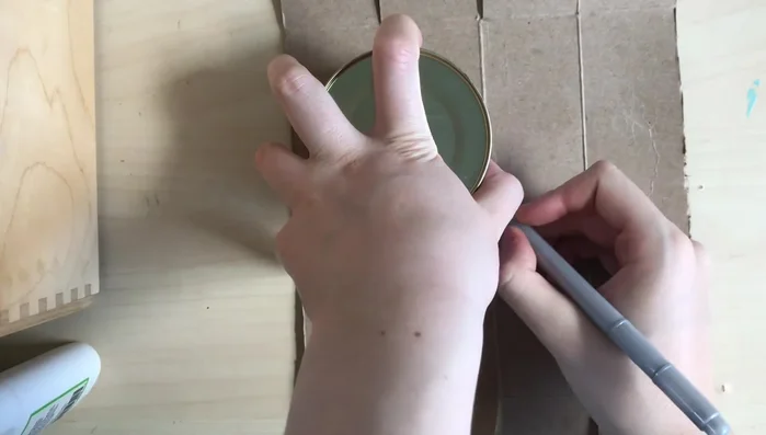 Attach the large pom-pom to the top of the hat, tying securely and weaving in loose ends.