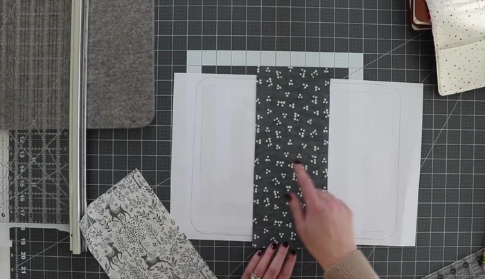 Cut fabric pieces: Cut fabric for the cover, larger than the template (allowing about an inch beyond the outer line). Create two different fabric pieces for a binding look. Cut additional pieces for the inside (including quilting backing). Account for seam allowances.