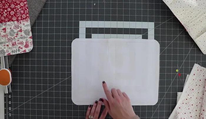 Attach pockets: Position pockets onto the uncut rectangle, stitching them in place with a basting stitch.