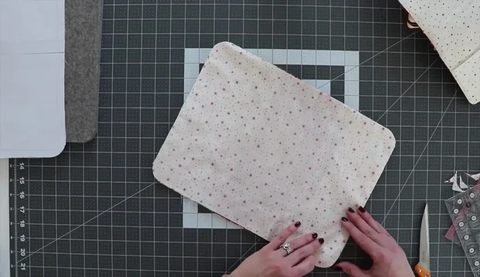 Sew cover and interior together: Pin the quilted cover and pocket-attached rectangle, right sides together, ensuring edges and corners align. Sew along all four sides, leaving a 5-inch gap for turning.