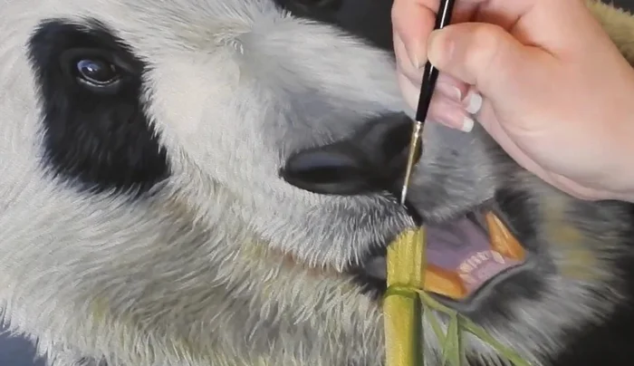 Refining details: Use a size 2 round brush and angled brush to refine details of the mouth, teeth, fur, and bamboo. Add finer hairs around the chin.