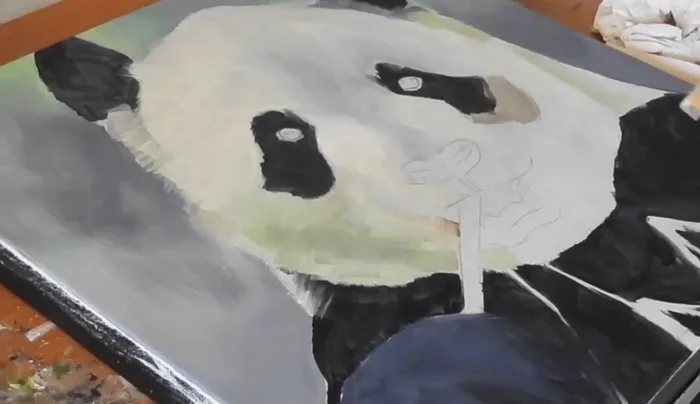 Blocking in with oils: Loosely apply initial colors for nose, muzzle, eyes, and background without precise color matching.