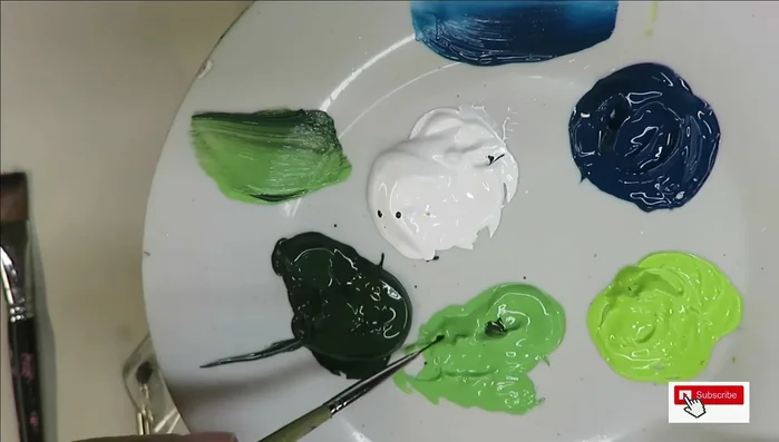 Outline floral design with fine liner: Use various paint colors and create scrolling lines to form the base for your flowers.