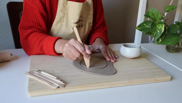 Carve out the shape for the candle holder base (circle, square, etc.).