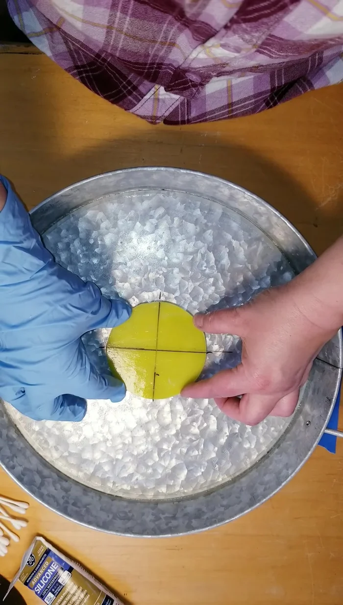 Center and adhere the circular glass piece to the tray, checking for even spacing with a ruler.