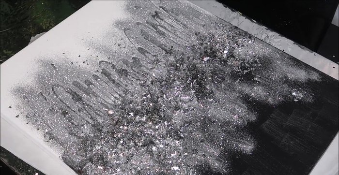 Use a clean, dry brush to gently remove any excess glitter and glass from the canvas.