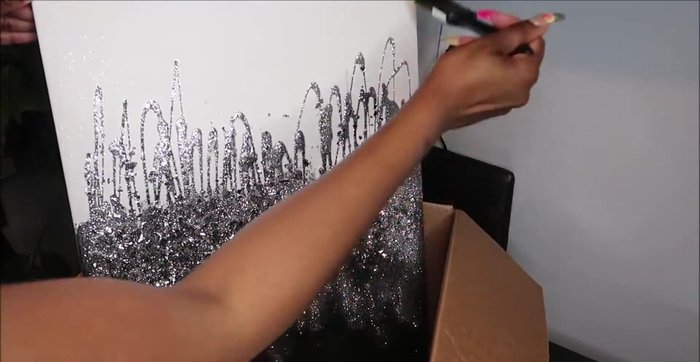 Use a clean, dry brush to gently remove any excess glitter and glass from the canvas.